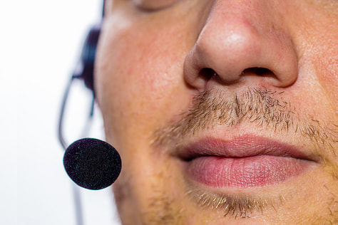 man speaking into a headset microphone